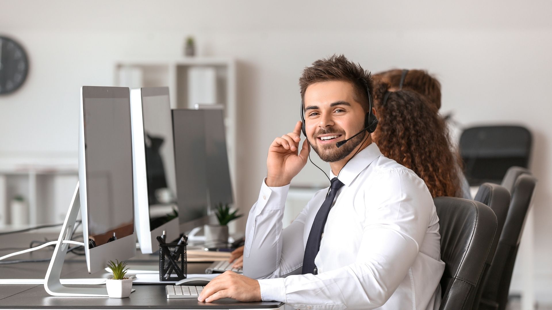 An agent smiling at a camera.