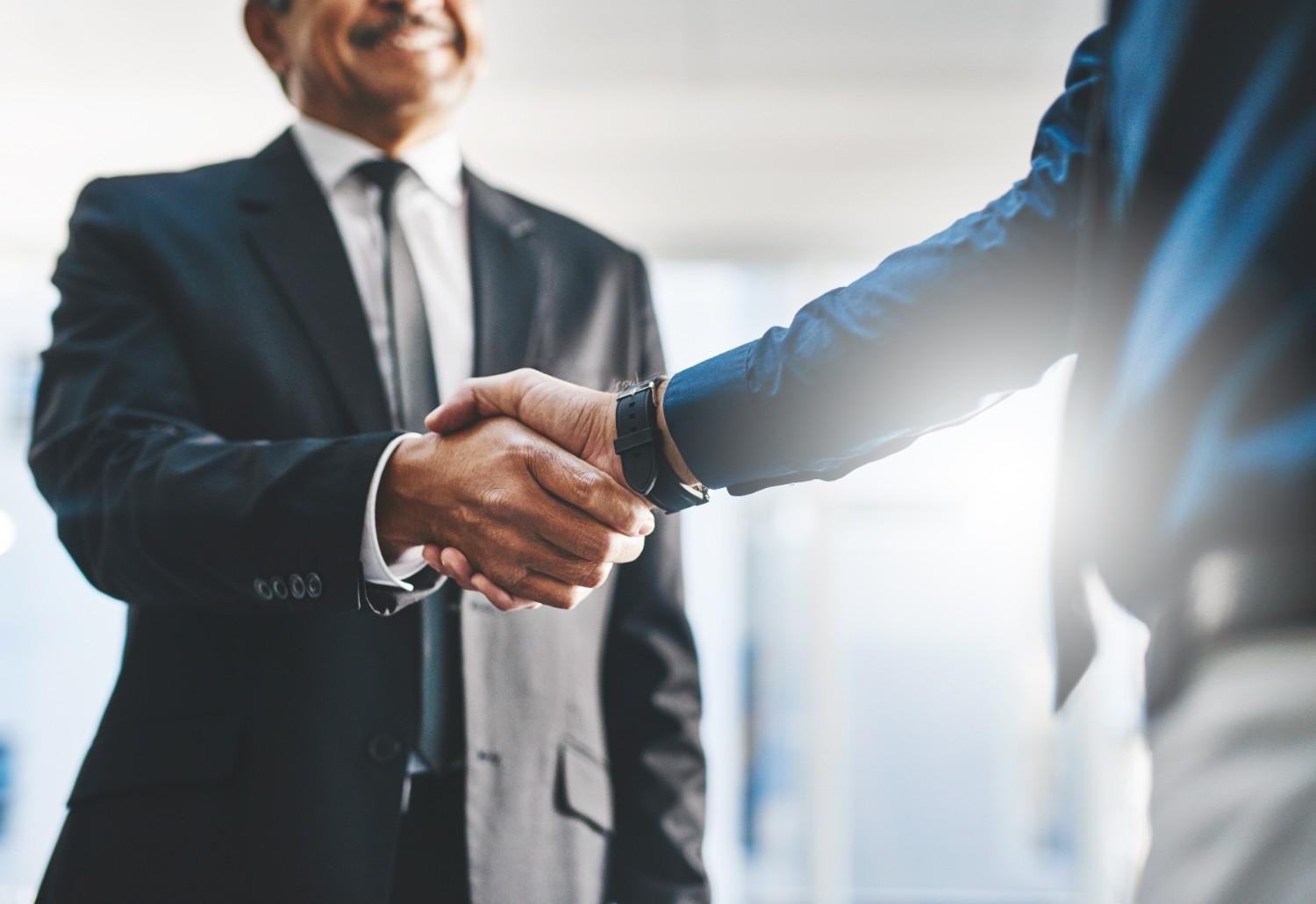 businessman shaking hands with reliable outsourcing partner