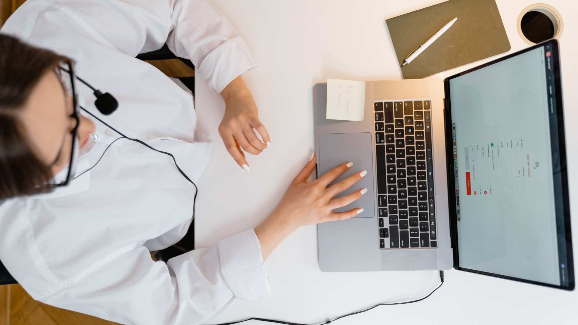 A call center agent working on their laptop device.
