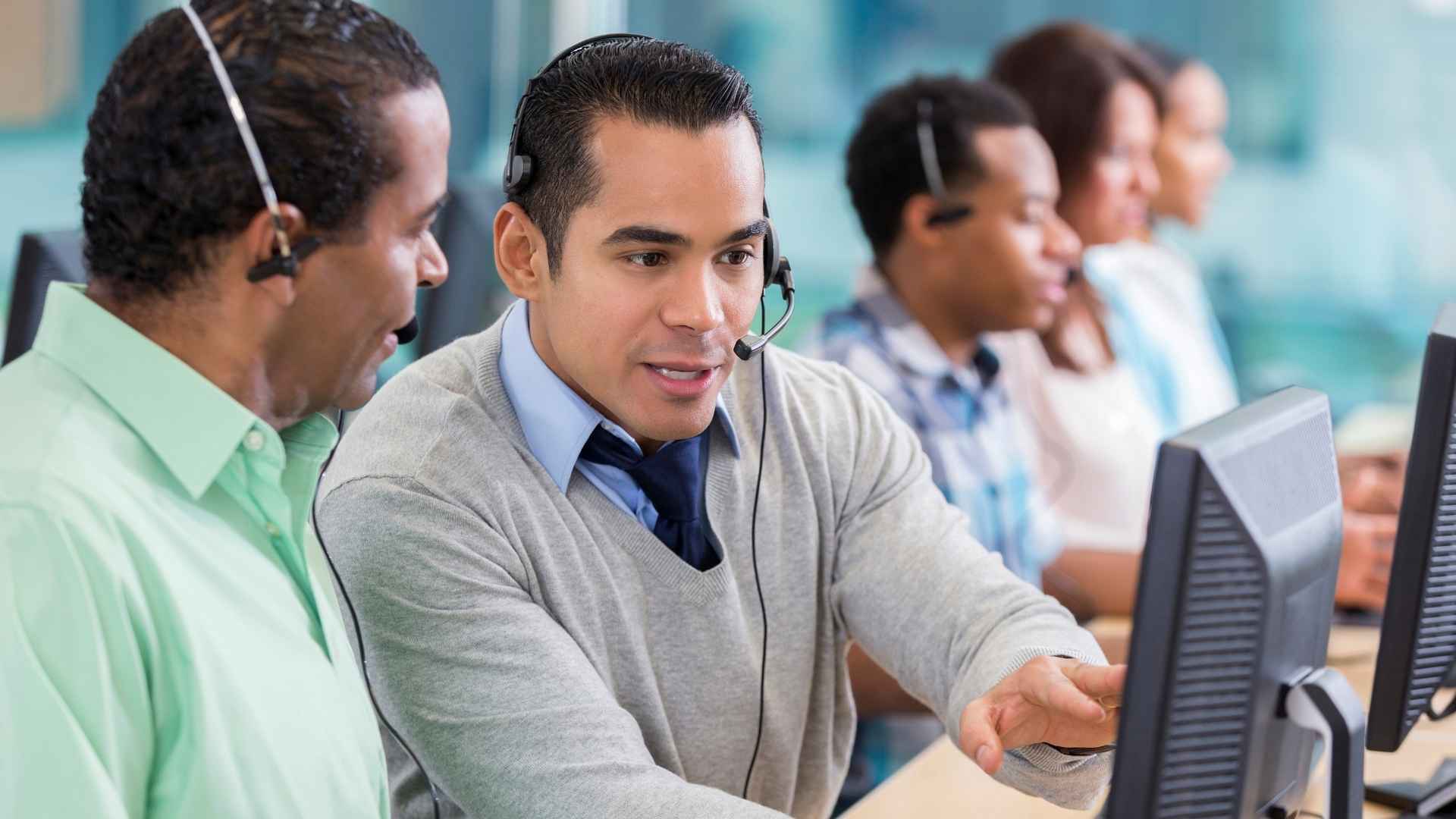 Call center staff collaborating at work.